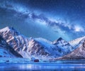 Milky Way above houses and snow covered mountains in winter Royalty Free Stock Photo