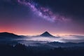Milky Way above mountains in fog at night in autumn. Landscape with hills valley Royalty Free Stock Photo