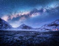 Milky Way above snow covered mountains and stones beach in winter Royalty Free Stock Photo