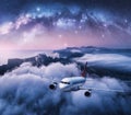 Milky Way arch and airplane is flying over clouds at night