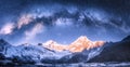 Milky Way arch over snowy mountains at starry night in winter. Royalty Free Stock Photo