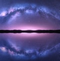 Milky Way arch reflected in water. Night landscape