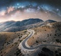 Milky Way arch and winding mountain road at night Royalty Free Stock Photo