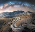 Milky Way arch and winding mountain road at night