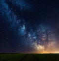 Milky way galaxy core over the track in the field