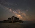 Milky Way Galaxy and meteor over Naturalist Shack Royalty Free Stock Photo