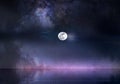 Milky way galaxy nebula   dark pink lilac  blue sky dramatic night clouds and bright full moon  at sea nature landscape Royalty Free Stock Photo