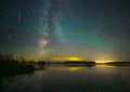 Milky way galaxy and perseid meteor shower. Green glow in the night sky.