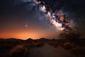 milky way galaxy, shining brightly in the night sky over desert landscape Royalty Free Stock Photo
