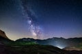 The Milky way galaxy and stars over the Italian French Alps. Night sky on majestic snowcapped mountains and glaciers. Meteor Royalty Free Stock Photo