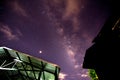 Milky way glaxy and stars with house roof top.