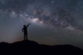 Milky Way landscape. Silhouette of Happy man standing on top of Royalty Free Stock Photo