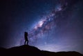 Milky Way landscape. Silhouette of Happy woman taking a bright star photograph Royalty Free Stock Photo