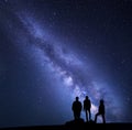 Milky Way. Night sky and silhouette of a family Royalty Free Stock Photo