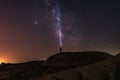 Milky Way on night sky and standing man silhouette with flashlight . Colorful night landscape. Exploring universe