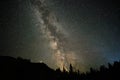 Milky way in the night sky. Starry sky and dark silhouettes of trees. Astrophotography. Royalty Free Stock Photo