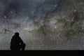 Milky Way. Night sky with stars and silhouette alone man looking Royalty Free Stock Photo