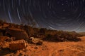 Milky Way over a lake in a granite quarry at night. Summer landscape with huge boulders, trees, purple sky with milky Royalty Free Stock Photo