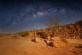 Milky Way over a lake in a granite quarry at night. Summer landscape with huge boulders, trees, purple sky with milky Royalty Free Stock Photo