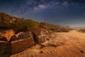 Milky Way over a lake in a granite quarry at night. Summer landscape with huge boulders, trees, purple sky with milky Royalty Free Stock Photo