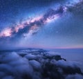 Milky Way over the low clouds and sea coast at starry night