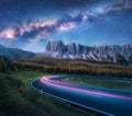 Milky Way over mountain road. Blurred car headlights Royalty Free Stock Photo
