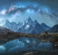 Milky Way over snowy mountains and lake at night. Landscape Royalty Free Stock Photo