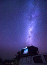 Milky way over a tent on the roof of a pickup car in the Namib desert of Namibia