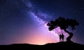 Milky Way with people under the tree on the hil Royalty Free Stock Photo