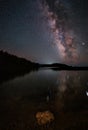 Milky Way and pink light at mountains. Night colorful landscape. Starry sky with hills at summer. Beautiful Universe. Space Royalty Free Stock Photo