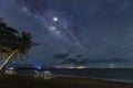 The Milky Way rises above the sea by the beach at night