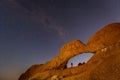 Milky Way shines over an arch in the desert