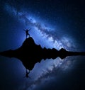 Milky Way. Silhouette of a happy man on the rock Royalty Free Stock Photo