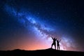 Milky Way and silhouette of happy people Royalty Free Stock Photo