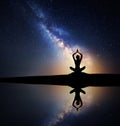 Milky Way with silhouette of a sitting woman practicing yoga Royalty Free Stock Photo