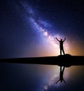 Milky Way and silhouette of a standing happy man Royalty Free Stock Photo