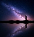 Milky Way. Silhouette of a standing man near the river Royalty Free Stock Photo