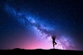 Milky Way with silhouette of a standing woman practicing yoga Royalty Free Stock Photo