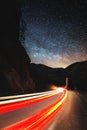 Milky Way Stars and cars lights trails in the road. Vertical orientation Royalty Free Stock Photo