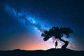 Milky Way, tree and silhouette of alone man. Night landscape Royalty Free Stock Photo