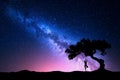 Milky Way with tree and a woman practicing yoga Royalty Free Stock Photo