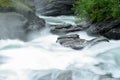 Milky white massive long waterfall down slippery valley rocks and stones in summer Royalty Free Stock Photo