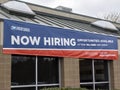 Mill Creek, WA USA - circa April 2022: View of a Now Hiring sign outside of the Mill Creek United States Postal Service building