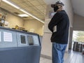 Mill Creek, WA USA - circa May 2022: Mid view shot of an older man waiting in line at the post office Royalty Free Stock Photo