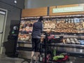 Mill Creek, WA USA - circa May 2022: View of a woman shopping for mushrooms inside a Town and Country grocery store