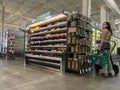 Mill Creek, WA USA - circa October 2022: Wide view of a woman with a baby stroller holding a shopping basket inside a Town and Royalty Free Stock Photo