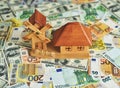 Mill layout on dollars and euro banknotes Royalty Free Stock Photo