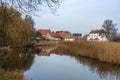 Mill pond and old houses with reflection in the small town Rehna in Mecklenburg-Vorpommern, northern Germany, copy space Royalty Free Stock Photo