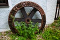 Mill wheel leaning against the house wall Royalty Free Stock Photo