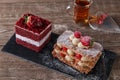 Mille feuille dessert sweet slice red velvet cake with white frosting is garnished with strawberries Royalty Free Stock Photo